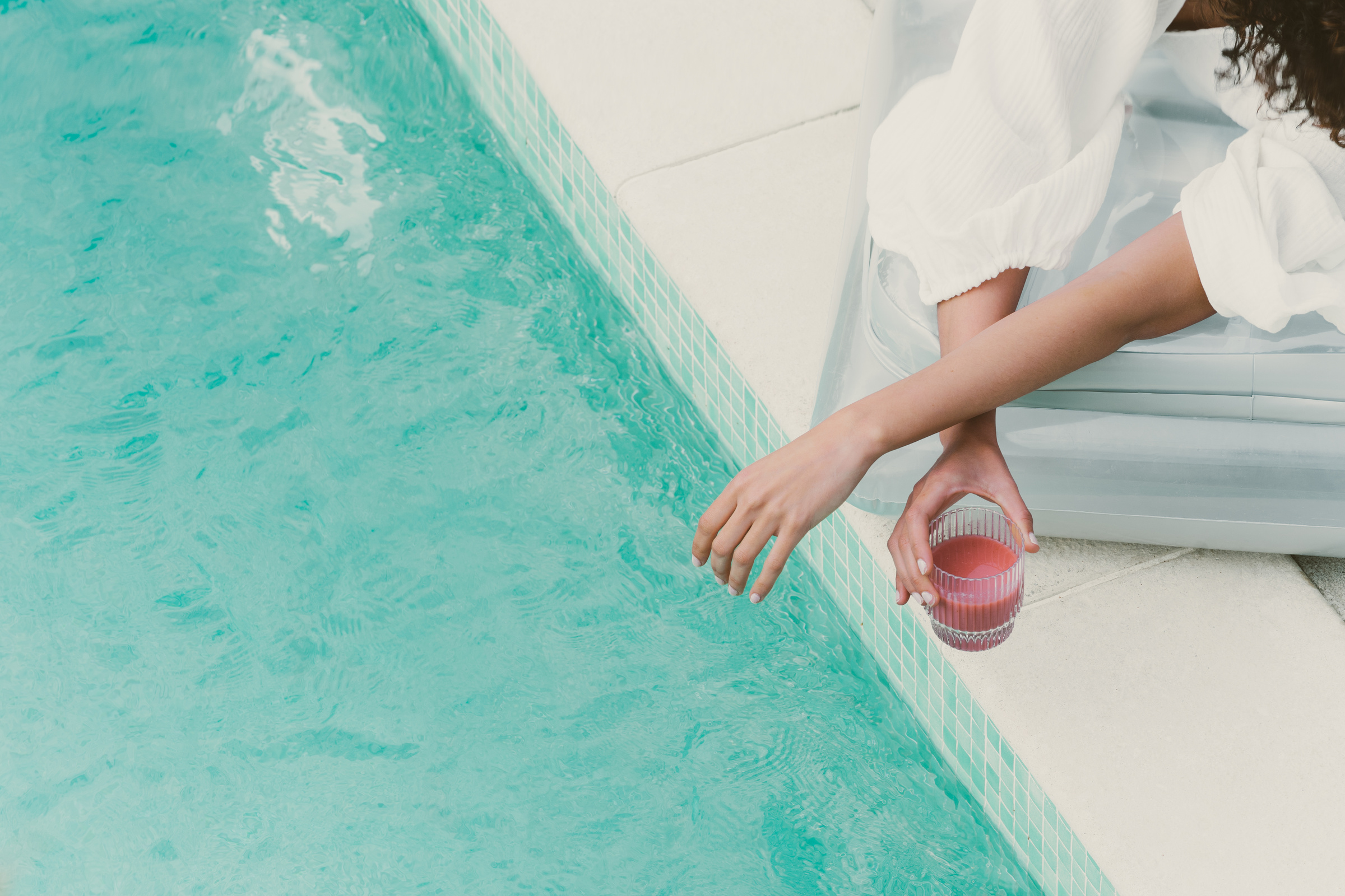 Pool Lifestyle Person Holding a Smoothie by a Pool